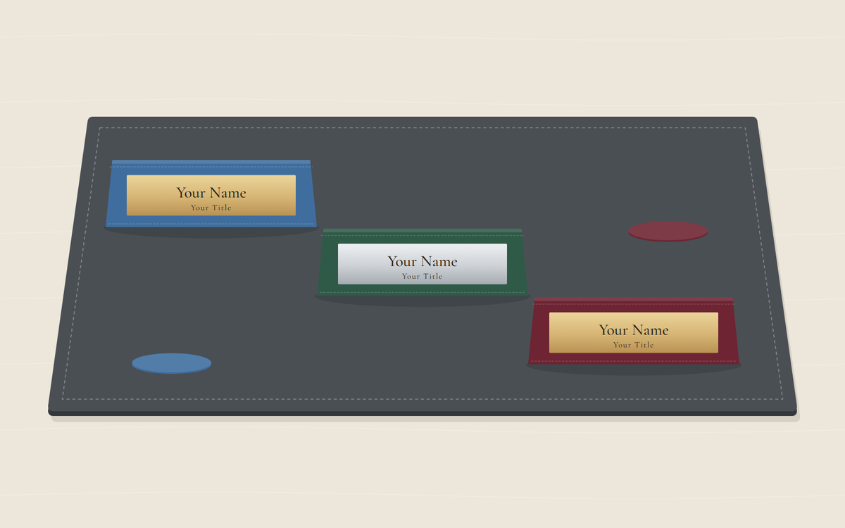 Illustration: three desk nameplates in blue, green and burgundy arranged in a diagonal row on a dark gray desk pad, each with a placeholder name on a gold or silver plate