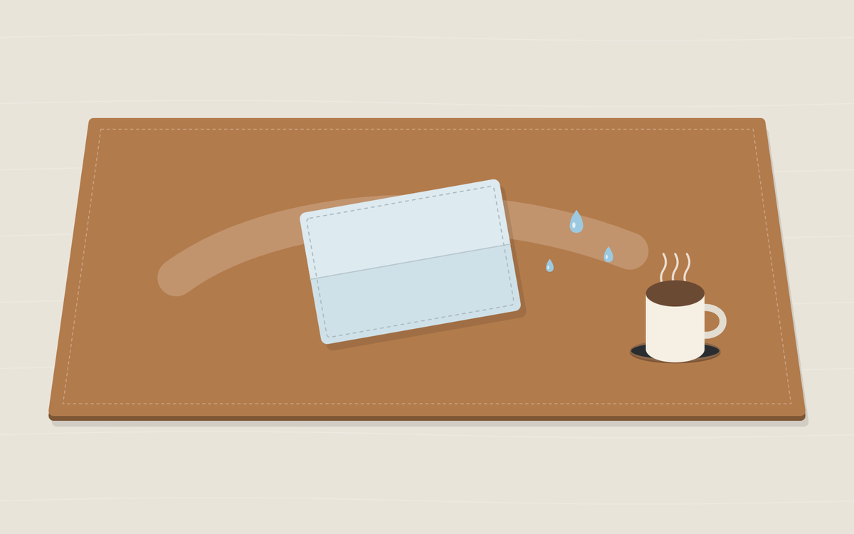Illustration: a tan desk pad with a folded pale blue cloth, a few drops of water and a wiped streak across the surface, and a cup standing on a coaster