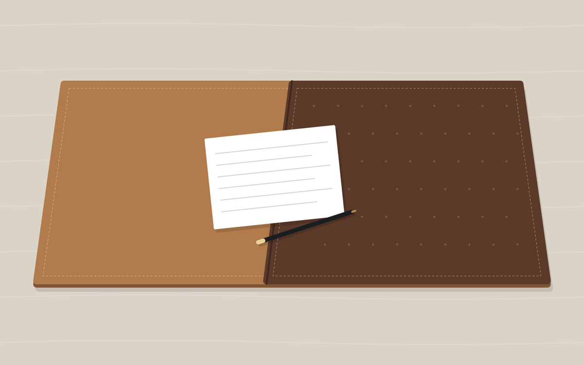 Illustration: a desk pad shown in two halves, one tan and smooth and one dark brown with a fine dotted grain, with a sheet of lined paper and a pen lying across the join