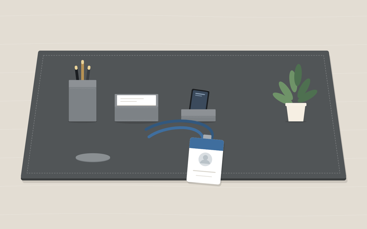 Illustration: a gray desk pad with a pen cup, a memo holder, a phone stand and a potted plant, and a blank staff ID badge on a blue lanyard lying in front