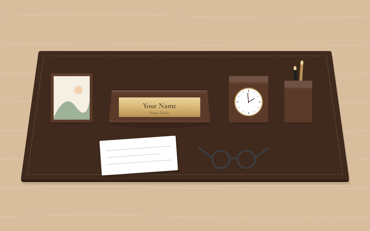 Illustration: a brown desk pad with a picture frame, a nameplate, a desk clock and a pen cup, and in front a note card and a pair of reading glasses