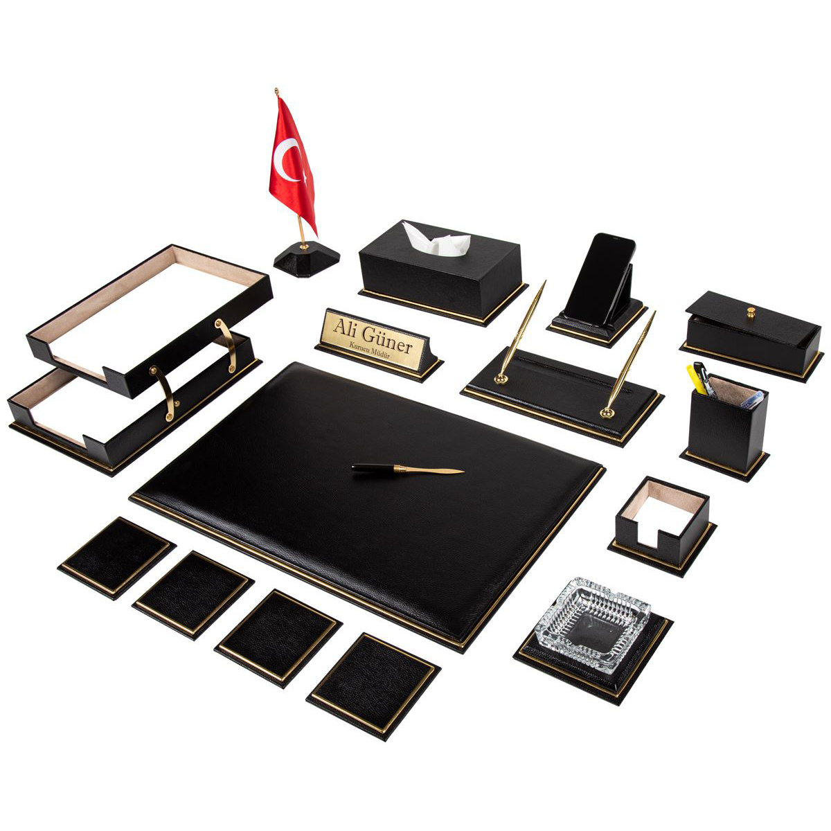 17-piece executive desk set in black with gold-tone trim: desk pad, desk flag, tray, tissue box, ashtray, four coasters, nameplate with sample text