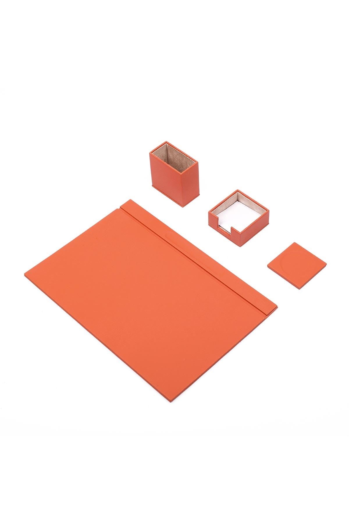 Luna 4-piece desk set in orange with a smooth matte finish: desk pad with top rail, pen cup, memo holder with notepaper and coaster